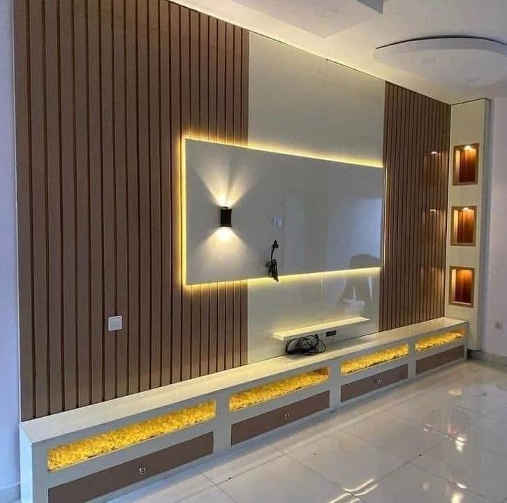 TV feature wall with built-in cabinetry and concealed lighting in a Doha living room (view 8)